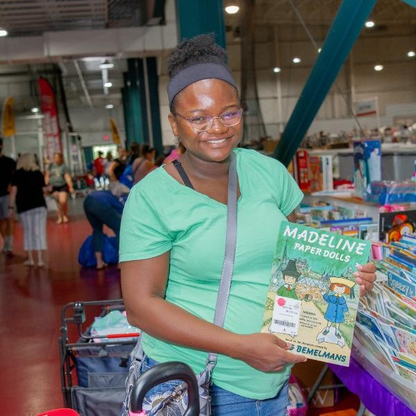 smiling woman holding a book