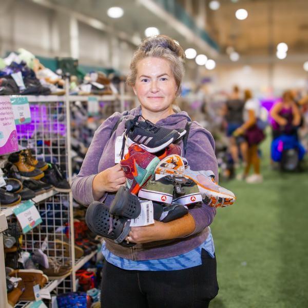 woman shopping and holding shoes