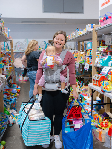 Mom wearing Baby shopping the infant items at the JBF Harrington sale