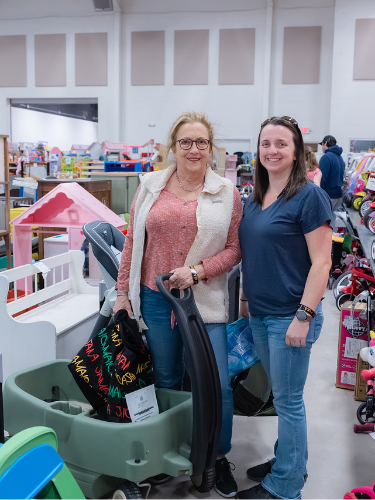 Two moms Shopping the wagons at the JBF Harrington sale