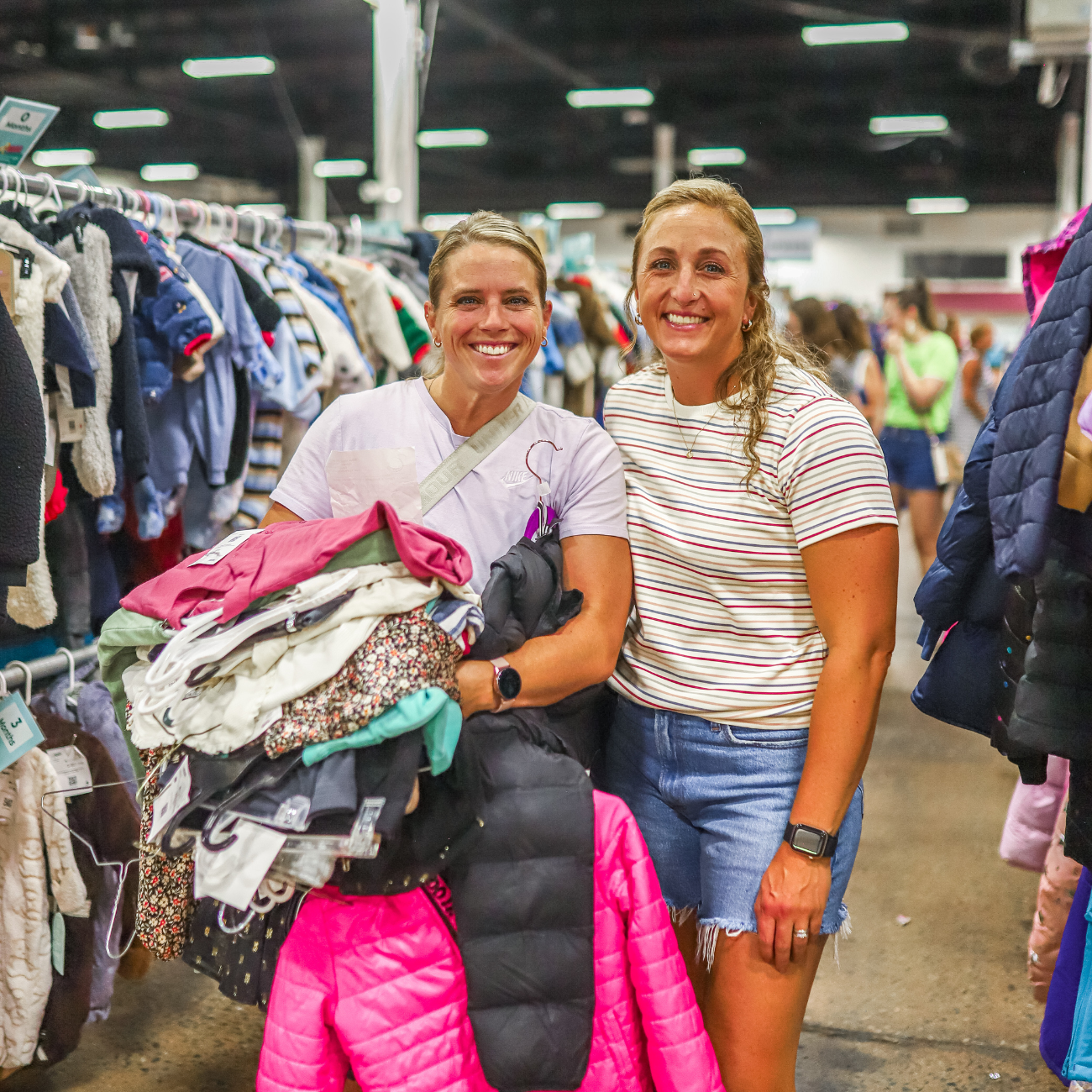 two smiling women shopping for clothing