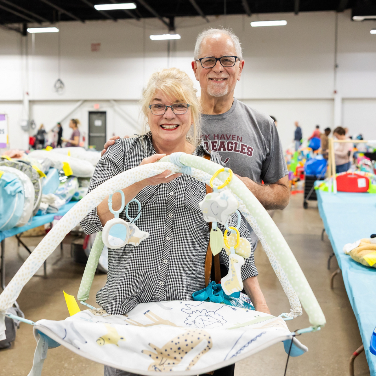 grandparents shopping for infant items and smiling